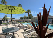 Thumbnail 2 of 36 - a swimming pool with tables and umbrellas