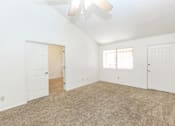 Thumbnail 5 of 13 - A room with white walls and a carpeted floor.