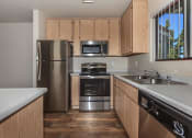 Thumbnail 13 of 33 - Sagecliff  kitchen with wooden cabinets and stainless steel appliances