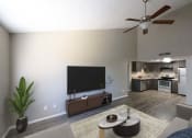 Thumbnail 4 of 36 - a living room with a flat screen tv and a kitchen