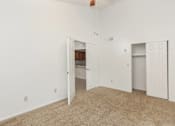 Thumbnail 8 of 13 - A room with a carpeted floor and two white doors.