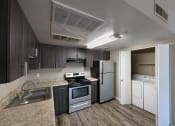 Thumbnail 6 of 36 - a kitchen with a stove refrigerator and a sink