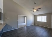 Thumbnail 7 of 36 - an empty living room with a ceiling fan