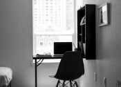 Thumbnail 16 of 33 - a black and white photo of a desk with a laptop
