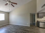 Thumbnail 11 of 36 - an empty living room and kitchen with a ceiling fan