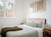 Thumbnail 12 of 30 - The Wes Gresham Oregon Apartments bedroom with a bed and window