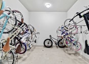 Thumbnail 31 of 33 - A room full of bicycles of various types and sizes.