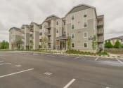 Thumbnail 21 of 21 - The Elwood Apartments Building Exterior and Parking Lot