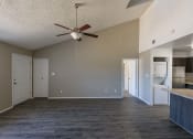 Thumbnail 13 of 36 - a empty living room with a ceiling fan