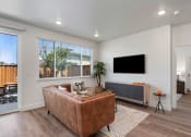 Thumbnail 17 of 30 - an open living room with a couch and a tv