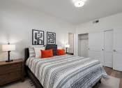 Thumbnail 19 of 30 - a bedroom with a large bed and white closets