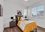 Thumbnail 8 of 30 - a bedroom with a bed and two windows
