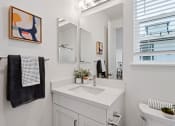 Thumbnail 7 of 30 - a white bathroom with a sink and a mirror