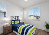 Thumbnail 6 of 30 - a bedroom with a bed and two windows
