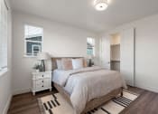 Thumbnail 4 of 30 - a bedroom with a bed and two windows