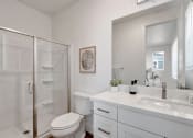 Thumbnail 5 of 30 - a white bathroom with a shower and a sink
