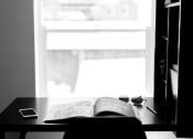 Thumbnail 31 of 33 - a book sitting on top of a desk next to a window