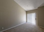 Thumbnail 16 of 36 - an empty living room with a sliding glass door