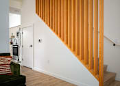 Thumbnail 17 of 30 - The Wes Gresham Oregon Apartments  wooden staircase with a white wall