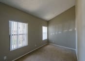 Thumbnail 17 of 36 - an empty living room with a large window and carpet