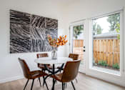 Thumbnail 18 of 30 - The Wes Gresham Oregon Apartments  Dining area with 4 chairs, table and flowers