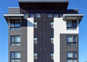 Thumbnail 8 of 33 - a tall building with a black and white facade