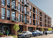 Thumbnail 1 of 27 - Arts Plaza Gresham Oregon Apartments A red brick building with balconies and cars parked in front.