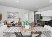 Thumbnail 5 of 21 - A modern living room with a glass table and white chairs.