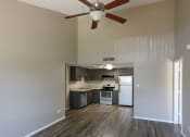 Thumbnail 20 of 36 - an empty kitchen with a ceiling fan