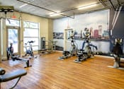 Thumbnail 23 of 29 - A gym with wooden floors and a city skyline mural on the wall.