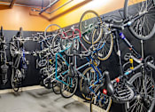 Thumbnail 20 of 29 - A wall of bicycles are parked in a bike shop.