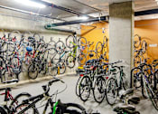 Thumbnail 21 of 29 - A bike rack full of bicycles in a parking garage.