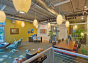 Thumbnail 15 of 29 - A modern office space with yellow walls and a glass railing.