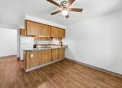 Thumbnail 8 of 25 - A kitchen with a wooden counter and a ceiling fan.