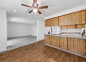 Thumbnail 7 of 25 - A room with wooden floors and a ceiling fan.