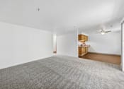Thumbnail 4 of 25 - A room with a grey carpet and a ceiling fan.