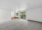 Thumbnail 9 of 25 - A spacious room with a grey carpet and white walls.
