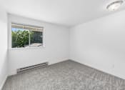 Thumbnail 16 of 25 - A room with a window and a radiator on the floor.