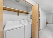 Thumbnail 5 of 25 - A laundry room with a washer and dryer.