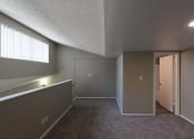 Thumbnail 23 of 36 - an empty living room with a door to a hallway and a window