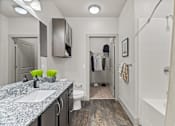 Thumbnail 7 of 33 - A bathroom with a white tub and a white toilet.