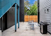 Thumbnail 30 of 30 - The Wes Gresham Oregon Apartments outdoor patio area with seating and bbq