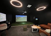 Thumbnail 12 of 53 - A room with a large screen and a couch.