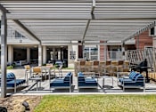 Thumbnail 28 of 53 - A patio with blue chairs and a white awning.