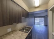 Thumbnail 26 of 36 - a kitchen with a sink and some wooden cabinets
