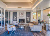 Thumbnail 28 of 36 - a living room with couches and chairs and a fireplace