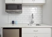 Thumbnail 20 of 33 - a kitchen with a sink and a microwave