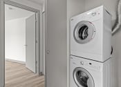 Thumbnail 24 of 28 - a washing machine and dryer in a white laundry room