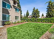 Thumbnail 19 of 28 - A well-maintained lawn in front of a residential building.