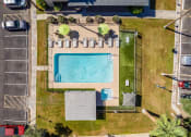 Thumbnail 35 of 36 - an aerial view of a swimming pool in a park with a fence